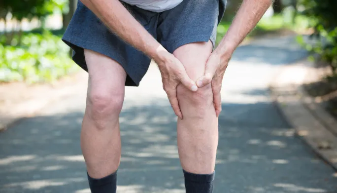 Therapist rehabilitating a patient's knee after an ACL injury