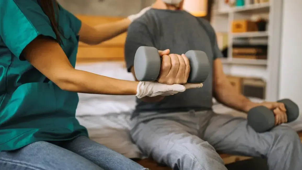 Therapist treating a patient's wrist and hand