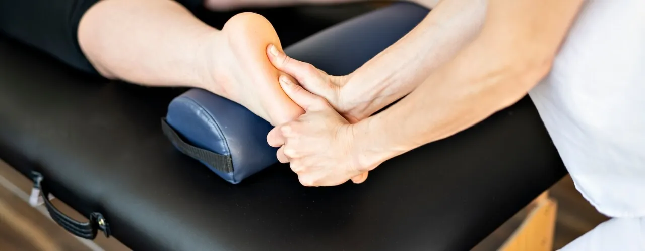 Physical therapist examining a patient's foot and ankle structure