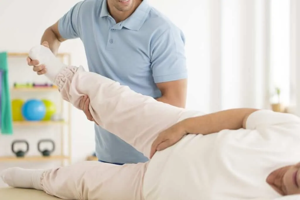 Physical therapist assessing hip and knee mechanics