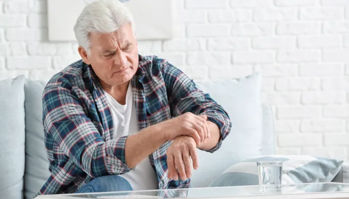 Therapist guiding a patient with Parkinson's through movement exercises