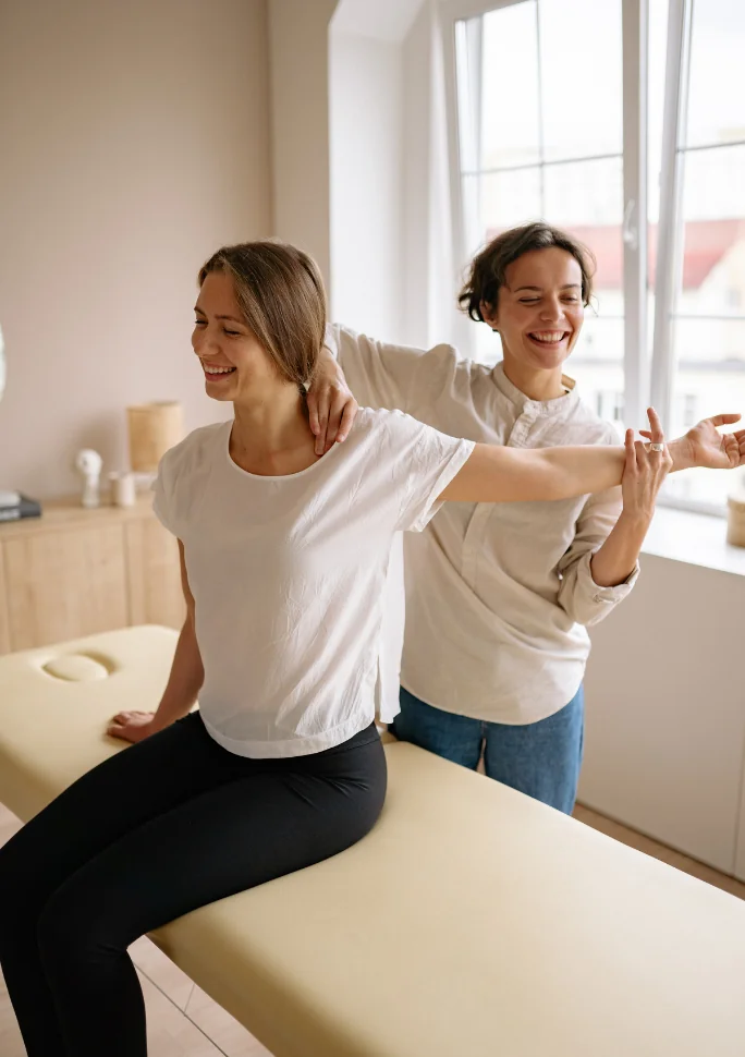 Therapist guiding a patient through an assisted shoulder stretch