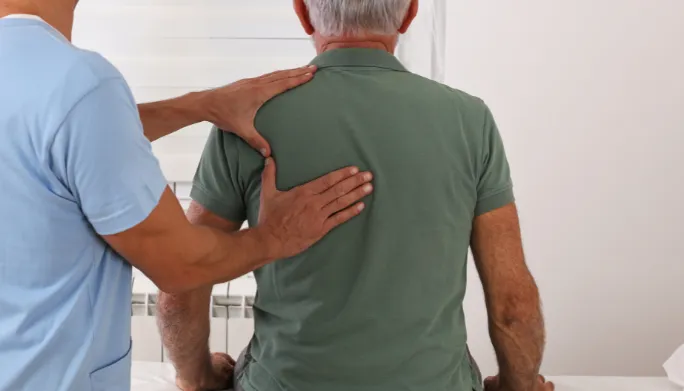 Therapist treating a patient's arthritic joint