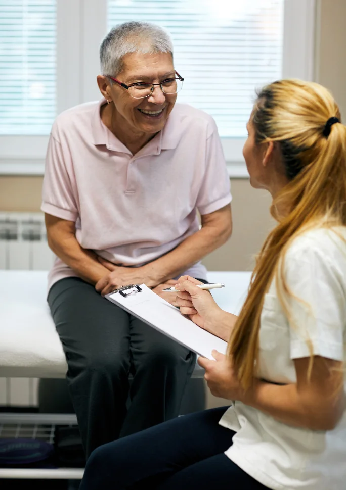 Physical therapist reviewing a treatment plan with a smiling patient